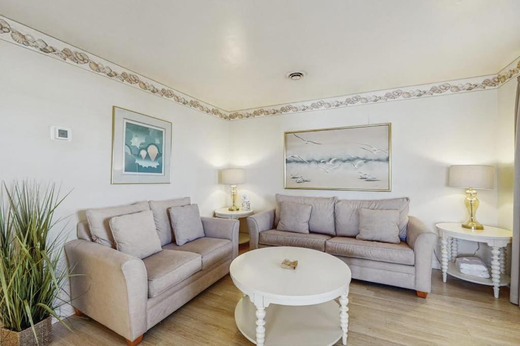 a living room with two couches and a table at 37534 Lighthouse Rd #202 in Fenwick Island