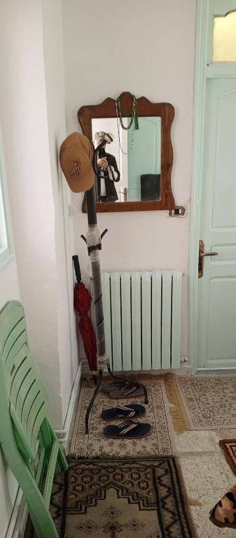 a corner of a room with a mirror and an umbrella at Dar Cherif in Kasbah