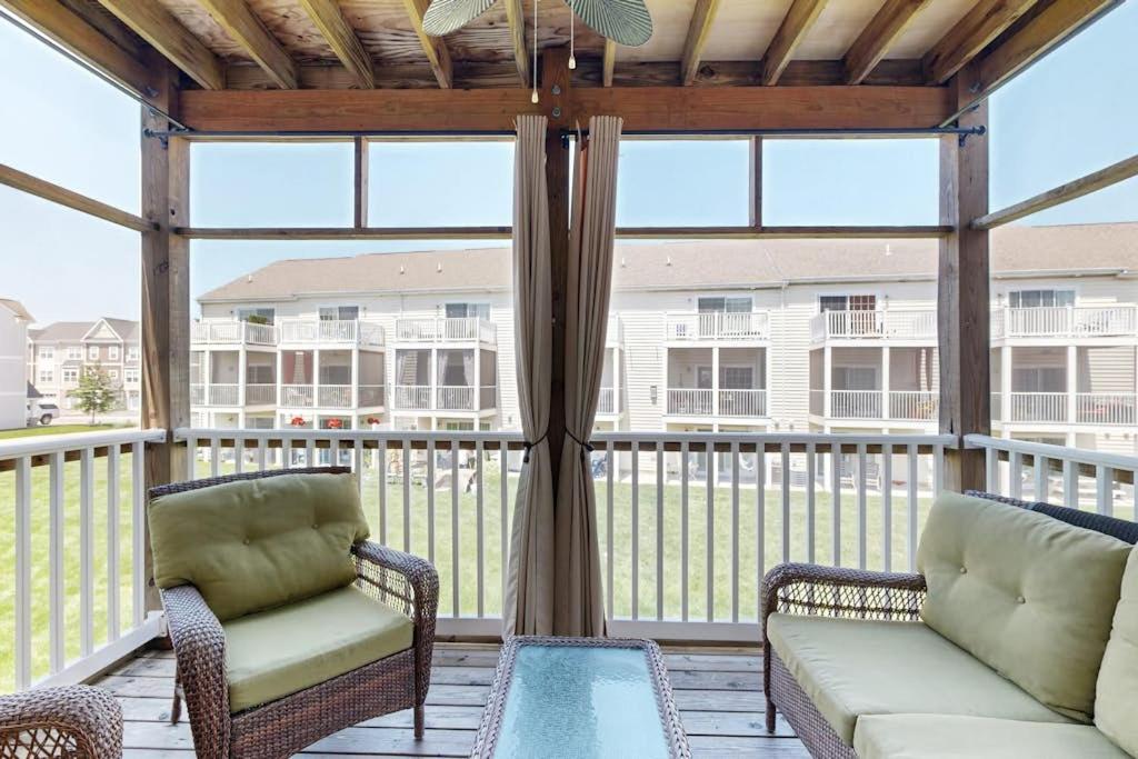 a screened in porch with two chairs and a couch at Rehoboth Crossing 19915 Ames Dr in Rehoboth Beach