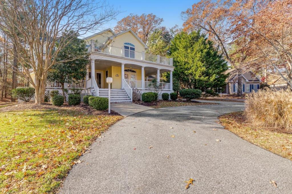 a white house with a porch and a driveway at Salt Pond -- 273 Oyster Shell Cove in Bethany Beach