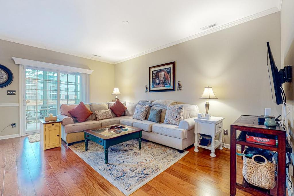 a living room with a couch and a table at The Tides --- 19979 Sandy Bottom Circle, Unit #504 in Rehoboth Beach
