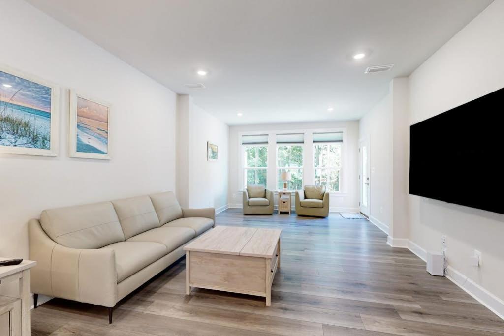a living room with a couch and a flat screen tv at The Peninsula --- 22198 Dune Cir in Millsboro