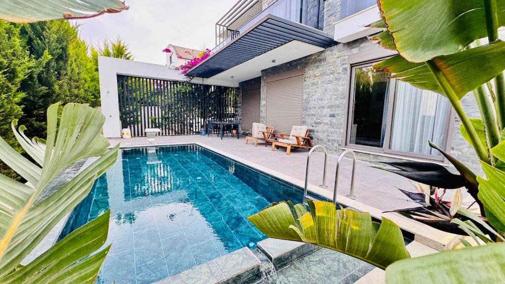 a swimming pool in the backyard of a house at Villa Maris Belek Villa in Belek