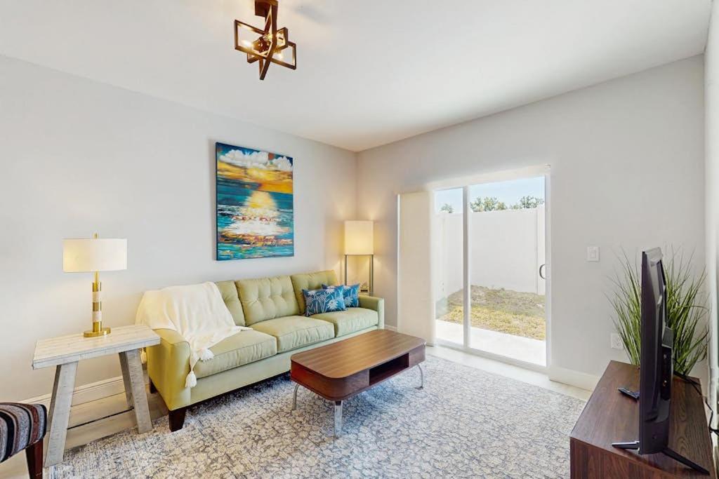 a living room with a couch and a tv at Sunny Shores- Sunrise in Englewood