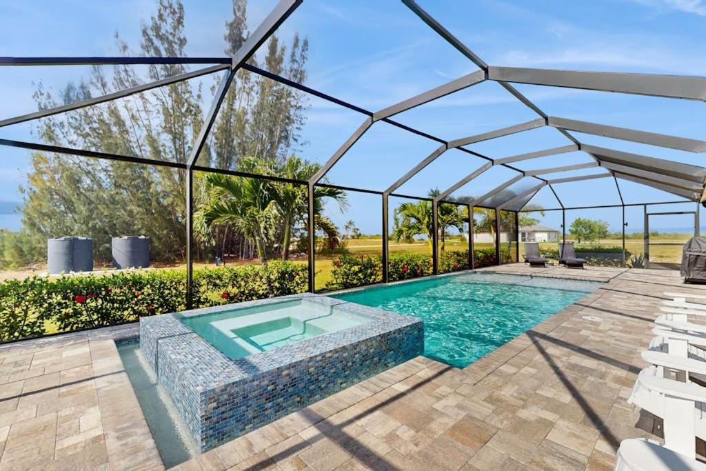 a swimming pool with a glass roof and a swimming poolvisor at Cocktail Cove in Cape Coral