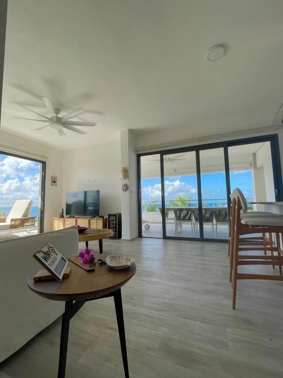a living room with a couch and a table at Penthouse In Tracadero Oceanfront Infinity Pool in La Laguna