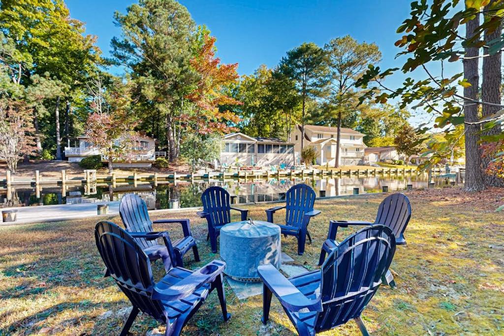 a group of chairs and a table in the grass at Battersea on the Canal in Ocean Pines