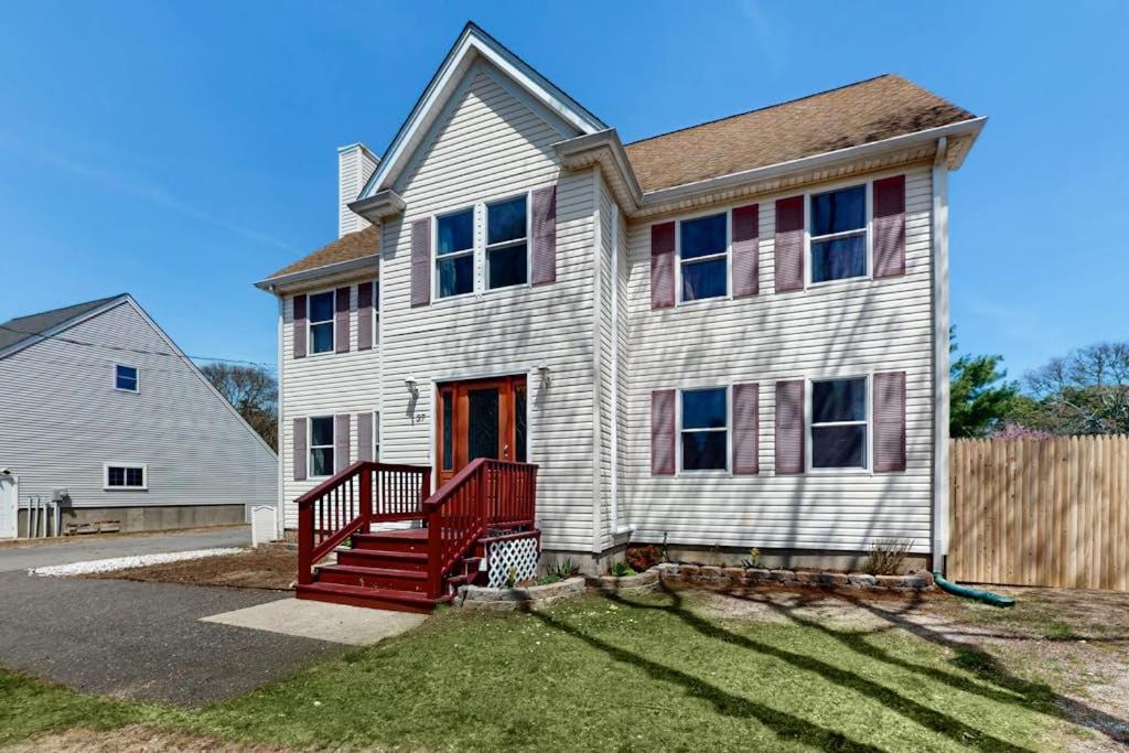 a large white house with a red porch at Buttermilk Bliss in Wareham