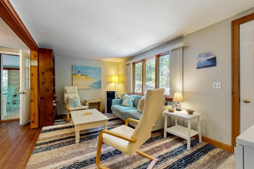 a living room with a couch and a table at The Woodland Cottage in Eastham