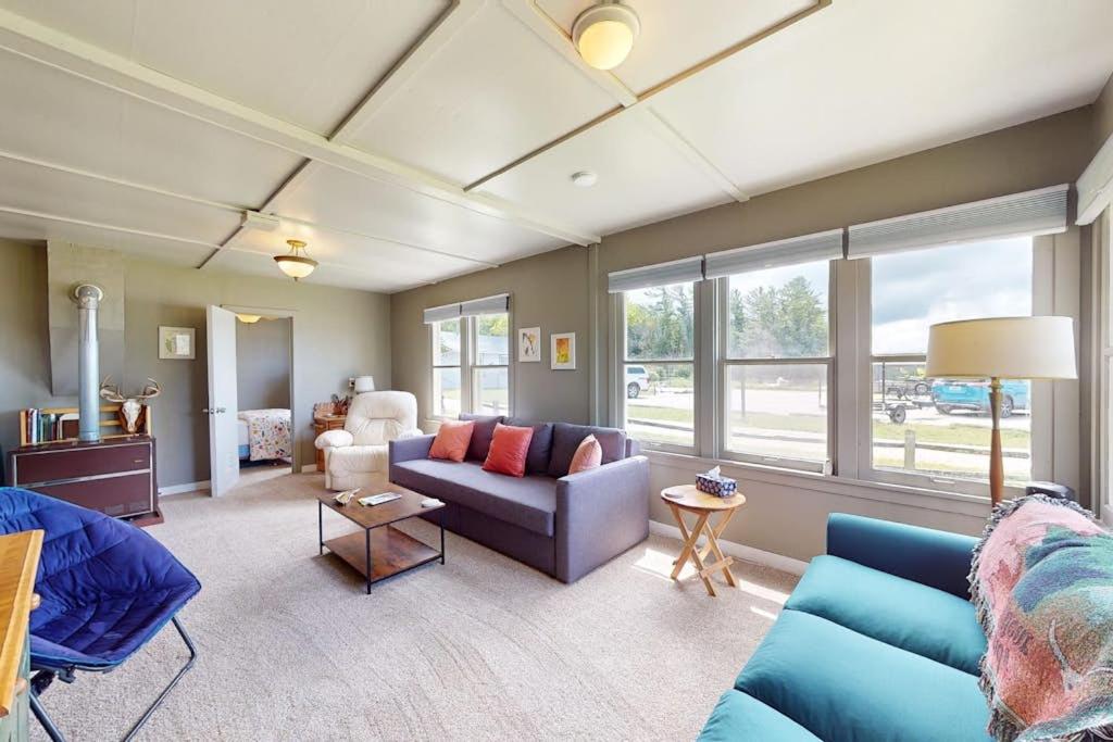 a living room with a blue couch and chairs at Green Cottage Getaway in Frankfort