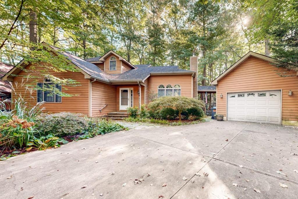 a wooden house with a garage and a driveway at Beaconhill Road 68 in Ocean Pines