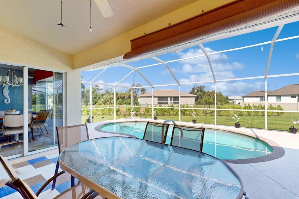 a room with a glass table and a swimming pool at Sunny Way in Rotunda-West