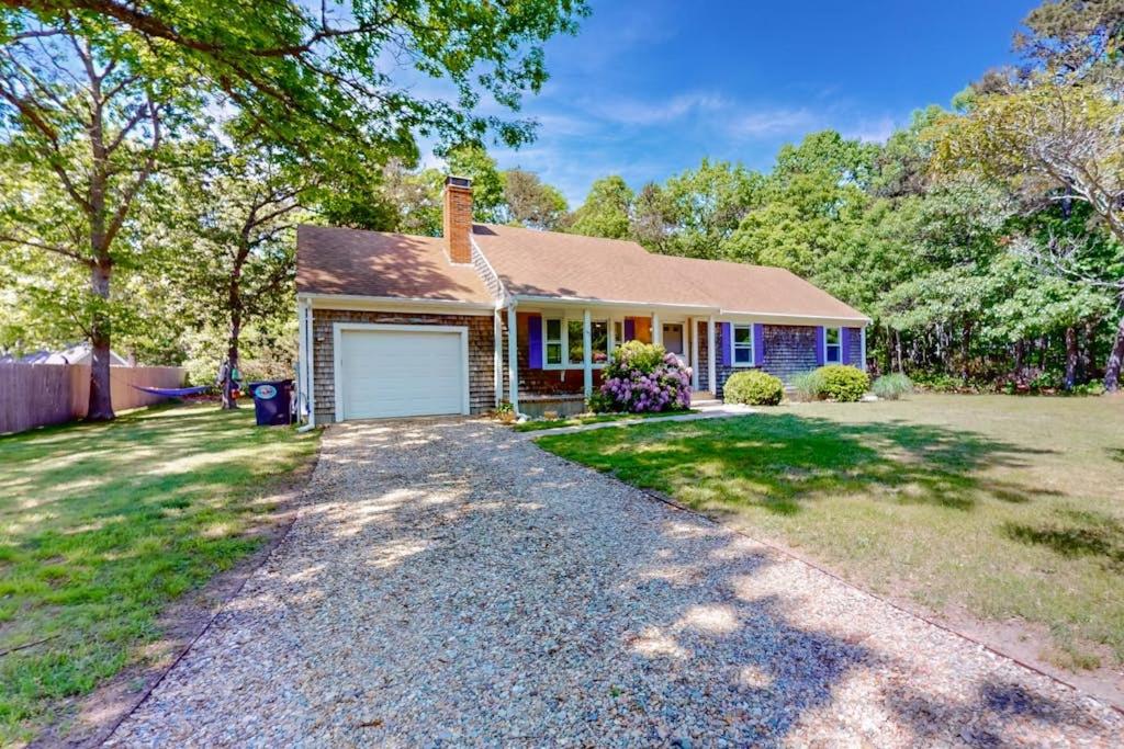a house with a driveway in front of it at The Blue Whale Cottage in Brewster