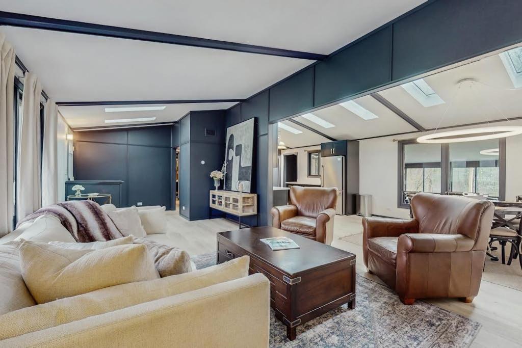 a living room with a couch and chairs and a table at La Casa Chikaming in Union Pier