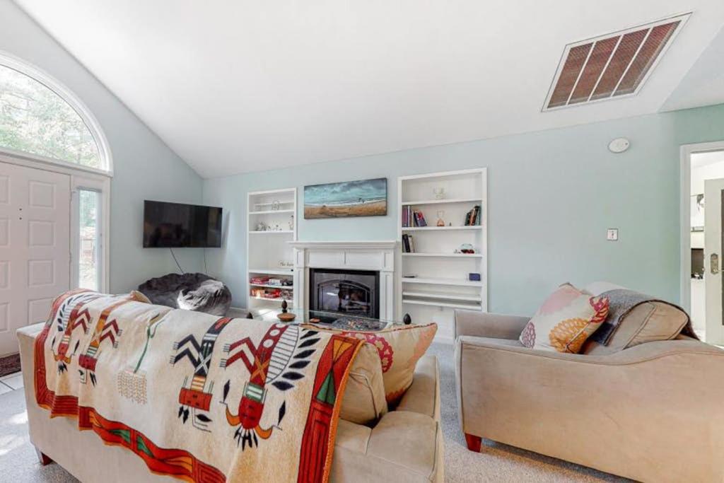 a living room with a dog sitting on a couch at Tranquil Woods in Ocean Pines