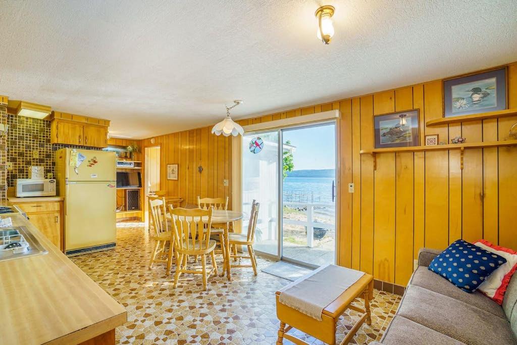 a kitchen and dining room with a table and a refrigerator at Grandma's Sandbox in Beulah
