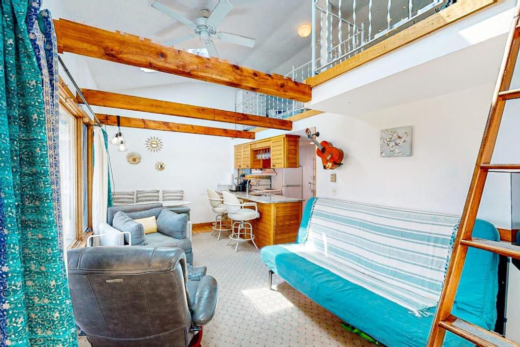 a bedroom with a bunk bed and a kitchen at Riviera Sunset in Chatham