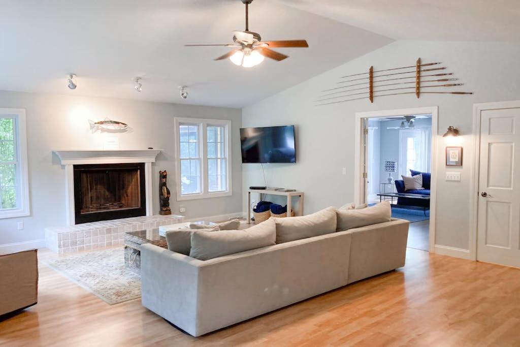 a living room with a couch and a fireplace at Ravenswood Pool House in Sawyer