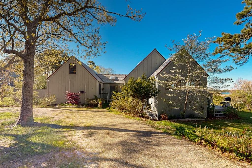 a barn with a tree next to a driveway at Soundmeadow House in Oak Bluffs