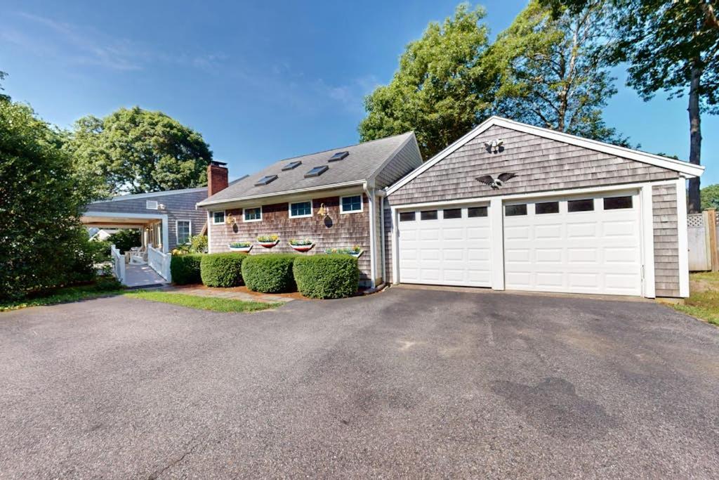 a brick house with a white garage at Seaside Park Retreat in West Hyannisport