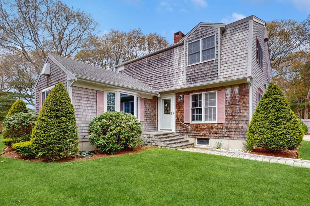a house with two trees in a yard at Wharf Side Hideout in Hyannis