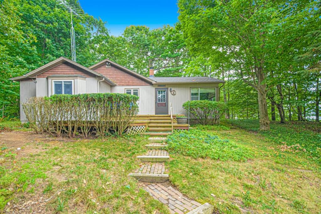 a house with a staircase in front of a yard at Johnson Cottage in Glenn