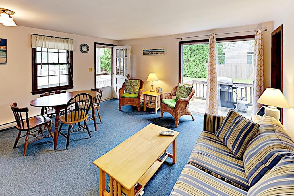 a living room with a couch and a table at Dennis Port Palace in Dennis Port