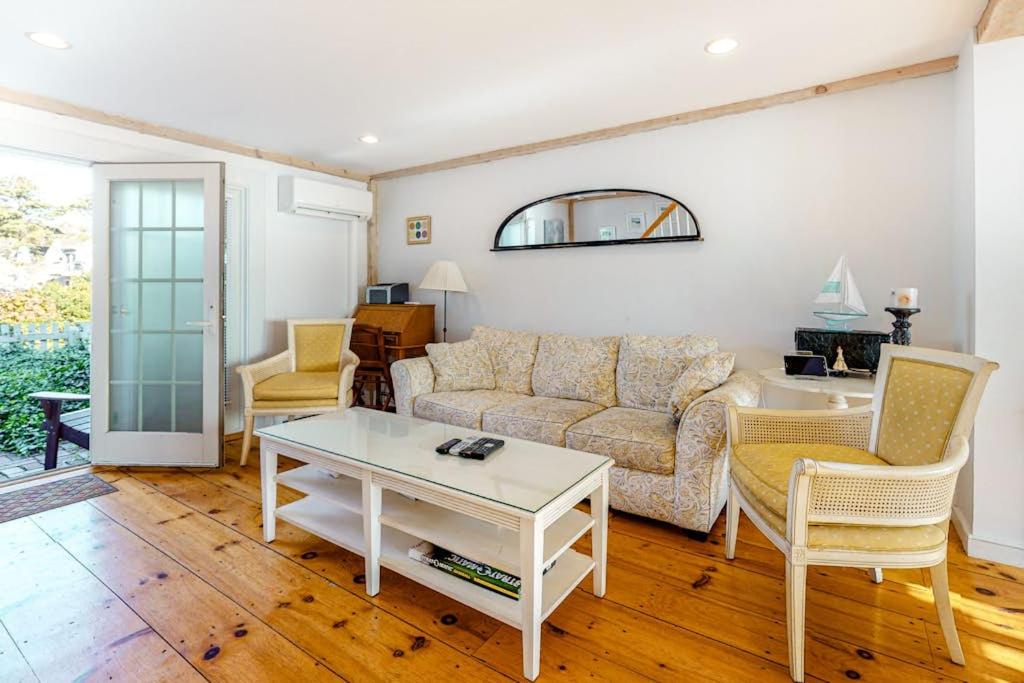 a living room with a couch and chairs and a table at Hammock Hideaway in Mashpee