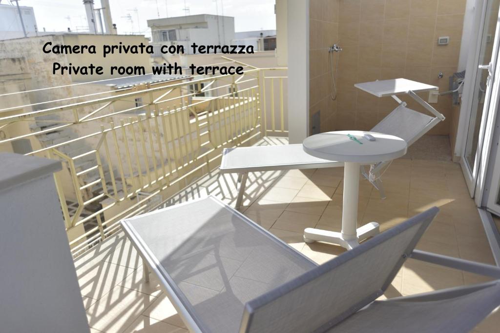 a balcony with two chairs and a table and a railing at Casa Nannì in Polignano a Mare