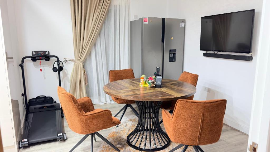 a dining room with a wooden table and chairs at Precise Homes in Wolverhampton