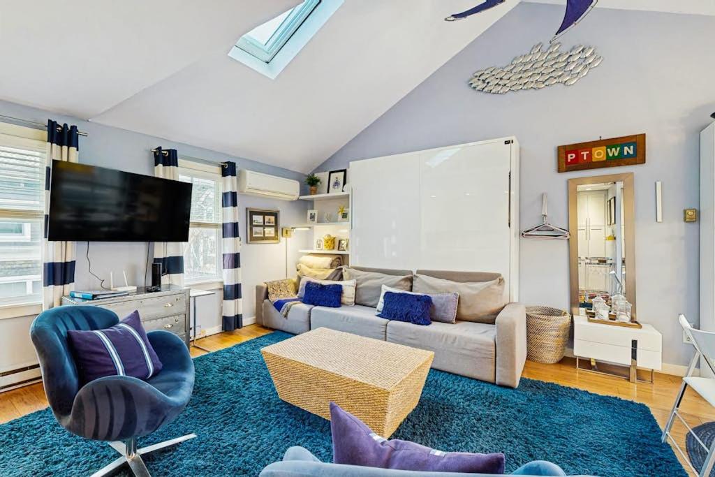 a living room with a couch and a tv at Provincetown Waterfront Studio in Provincetown