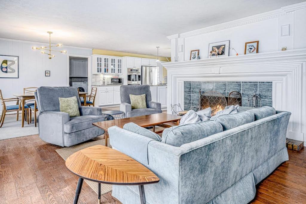 a living room with two couches and a fireplace at Birdie Bungalow in Saugatuck