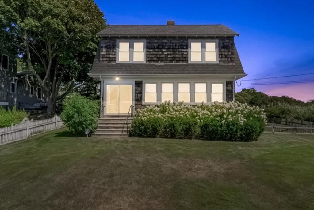 a house with a yard with a house at Bayview Bliss in West Yarmouth