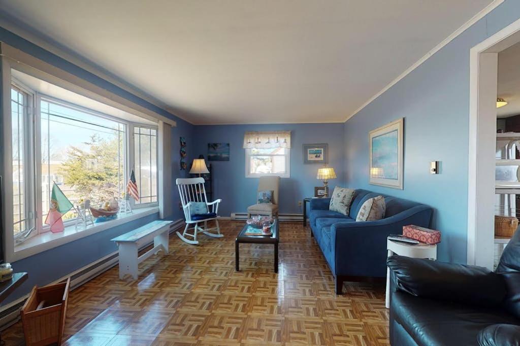 a living room with blue walls and a blue couch at Summer Get Away in Dennis Port