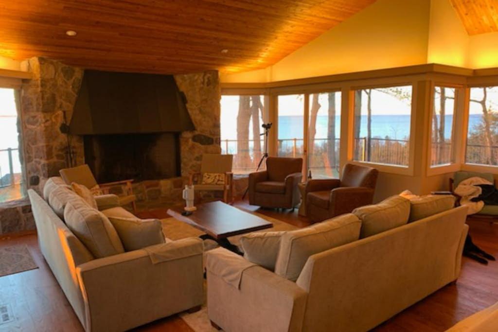 a large living room with couches and a fireplace at Tally-Sun on the Bluff in Harbor Springs