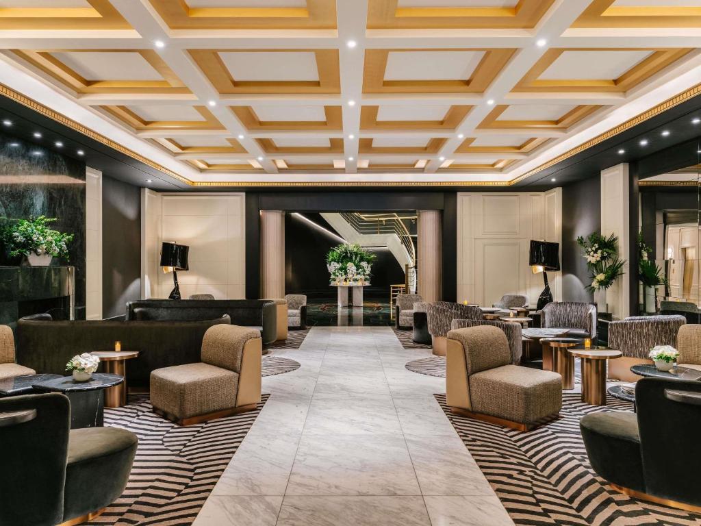 a lobby of a hotel with couches and tables at Sofitel New York in New York