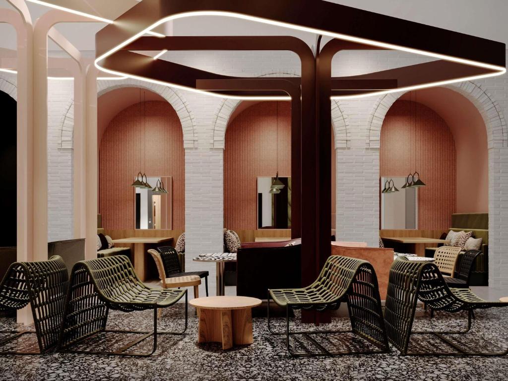 a lobby with chairs and a table and tables at TRIBE Strasbourg Centre Gare in Strasbourg