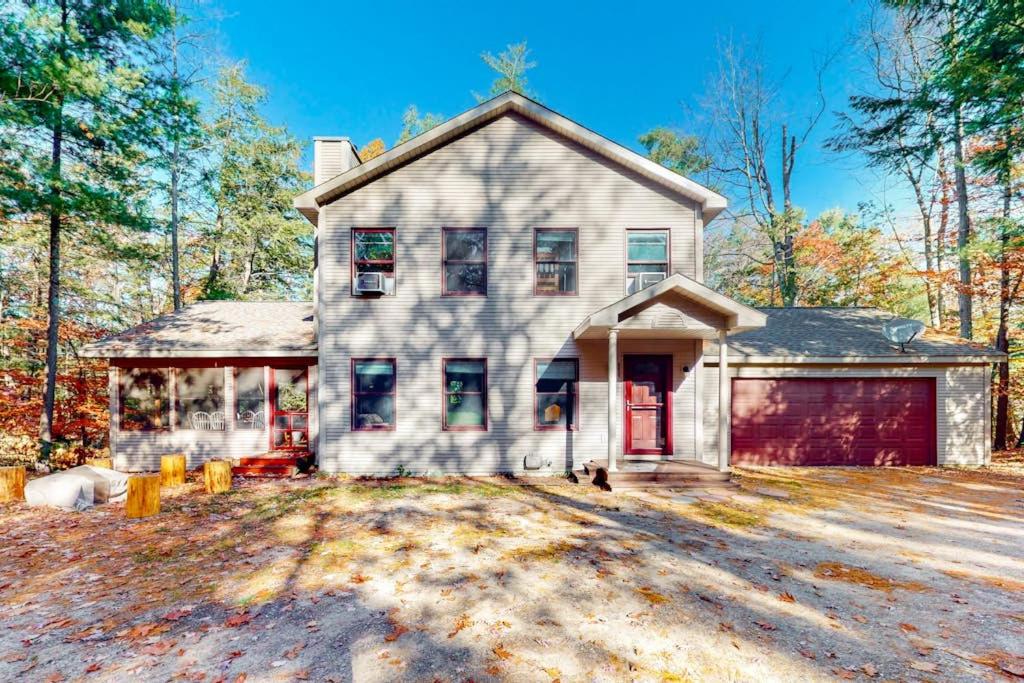 a large white house with a red garage at Absolute Leelanau in Glen Arbor