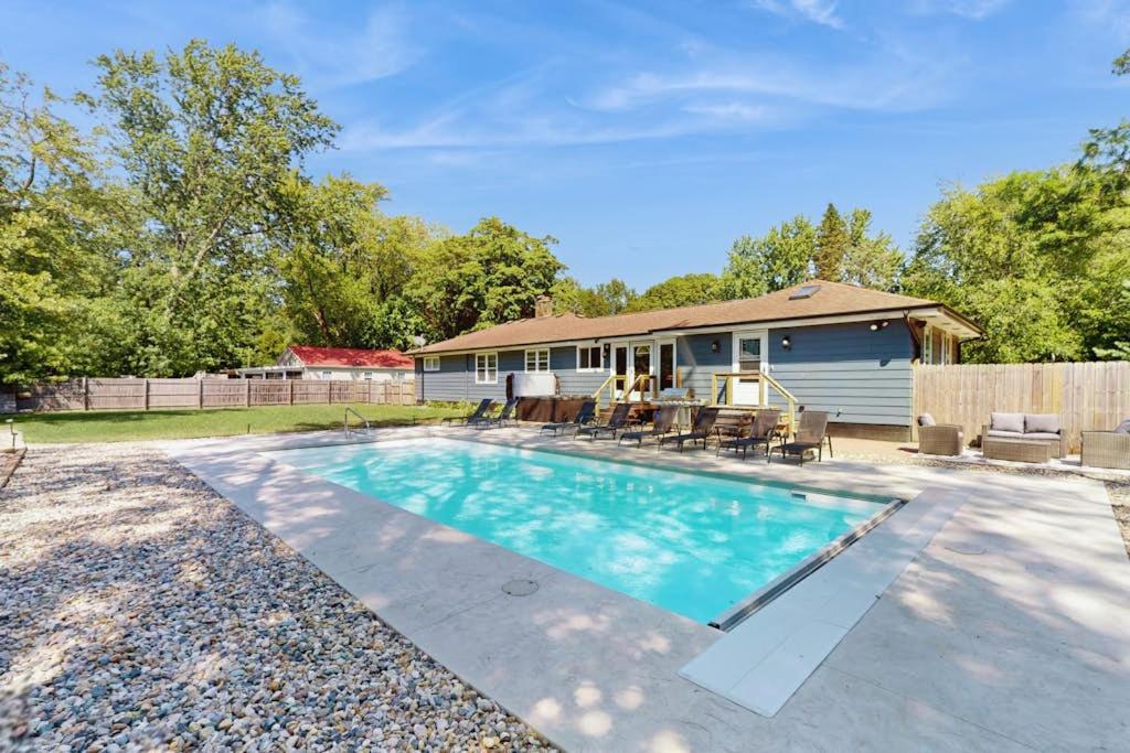 a swimming pool in front of a house at Charlotte’s Chateau in New Buffalo