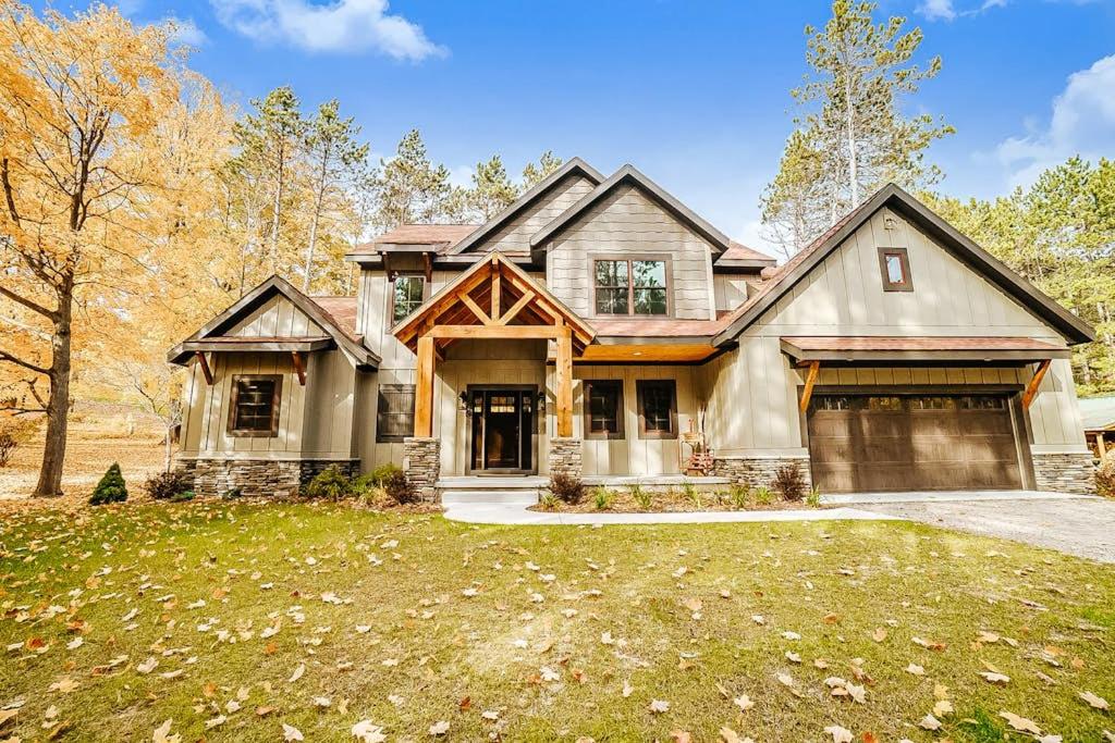a large house with a garage in a yard at Buckaroo in Thompsonville