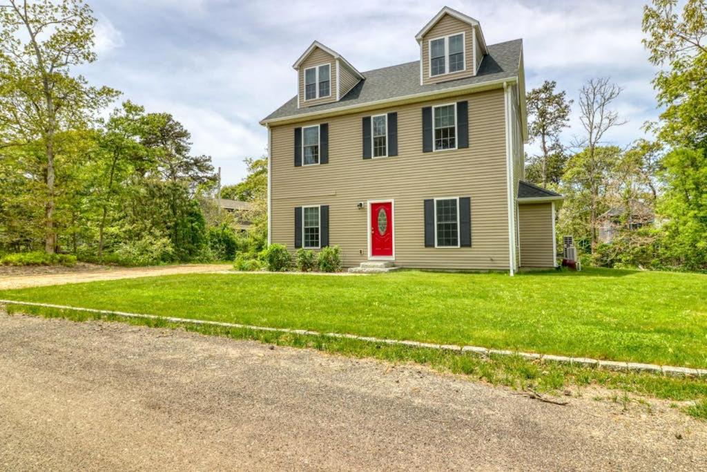 a house with a red door and a yard at Oak Bluffs Beauty in Oak Bluffs