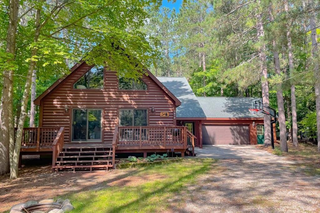 a log cabin with a porch and a driveway at Crystal Haven in Thompsonville