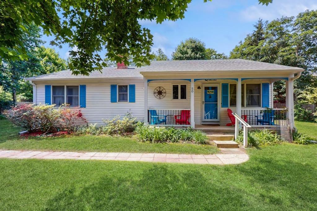 a white house with a blue door and a yard at Old Orchard in Edgartown