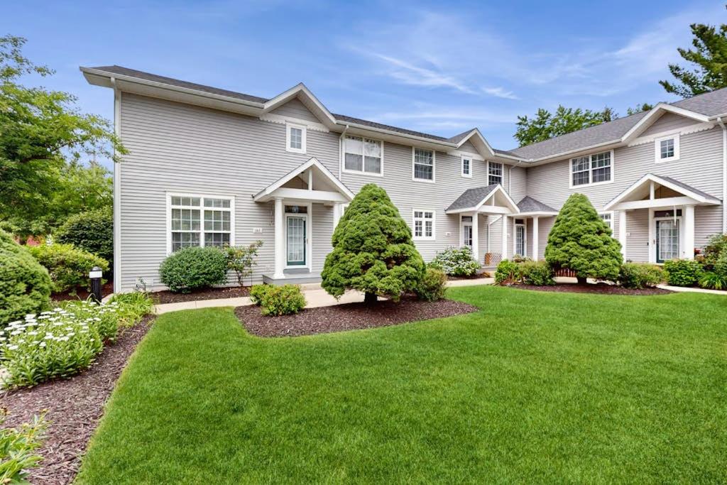 a large house with a yard with green grass at Beacon Court Condo F in Douglas