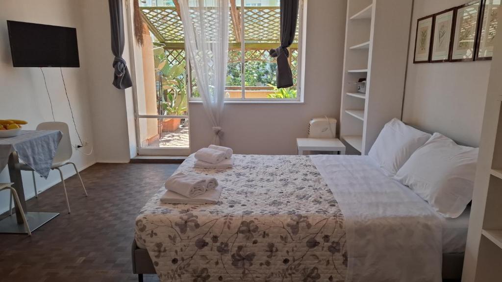 a bedroom with a bed and a large window at Rachana Guest House in Mestre