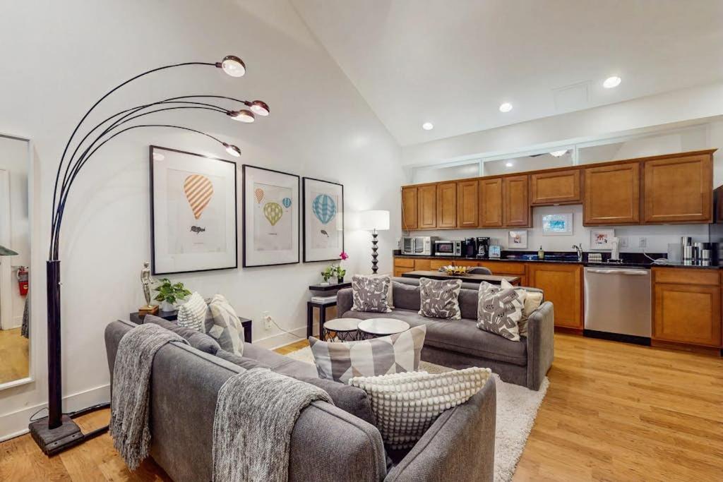 a living room with two couches and a kitchen at Arrowhead Resort - Undeniably Darling in Saugatuck
