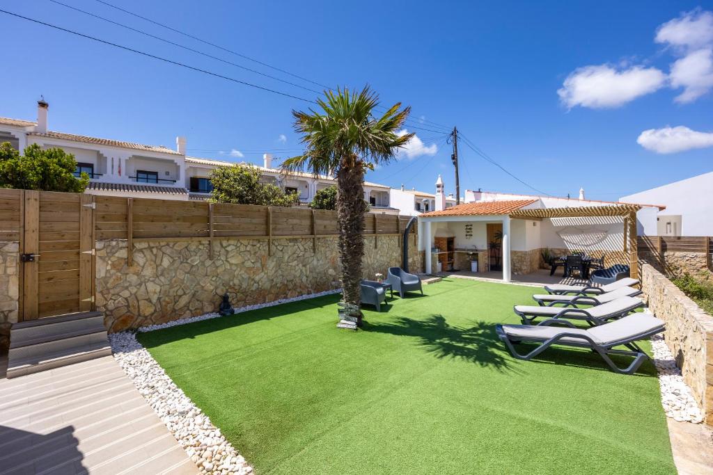 a backyard with lawn chairs and a basketball hoop at SagresSeaHouse in Sagres