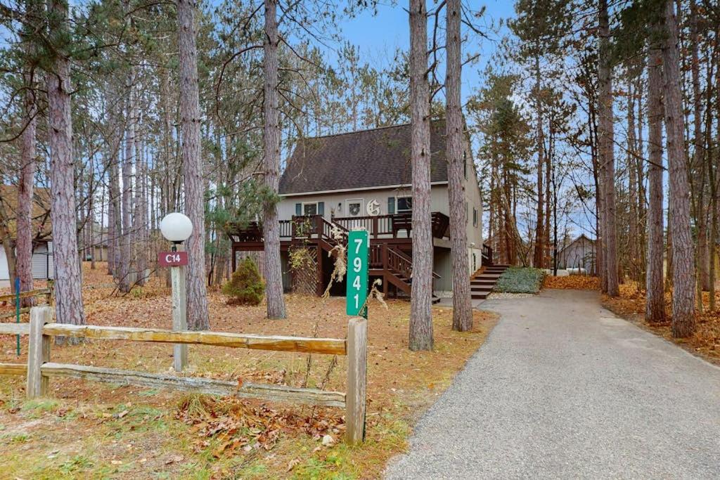 a house in the woods with a sign in front of it at Crystal Mountain Retreat in Thompsonville