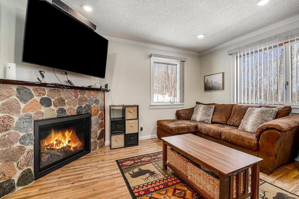 a living room with a couch and a fireplace at Hideaway Valley Condo 36 in Harbor Springs