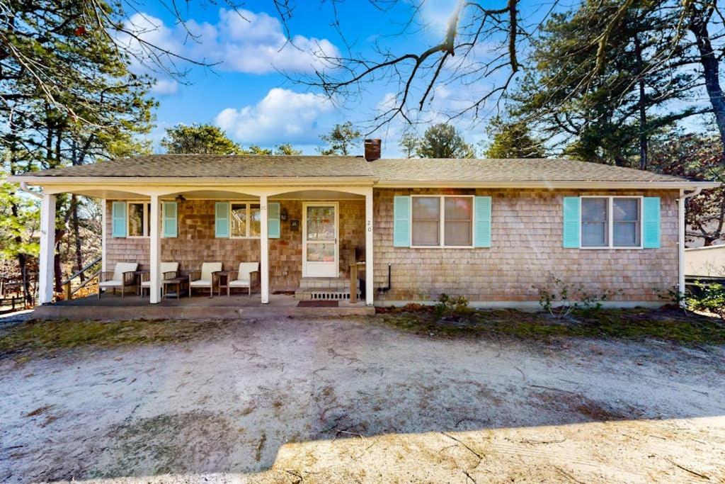 a home with a brick house with a porch at Eastham Glen in Eastham